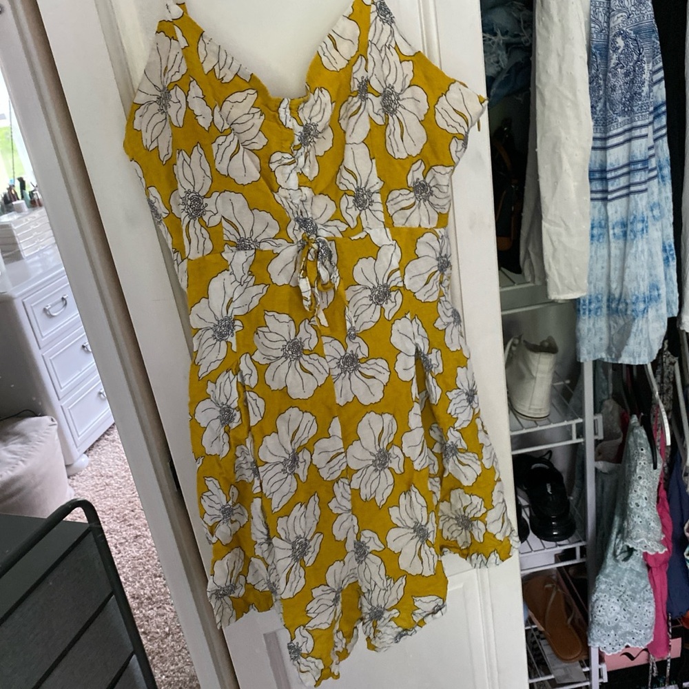 Yellow romper with white flowers and pockets